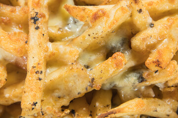 Cheese baked fries topped with rich black truffle sauce covering the entire plate