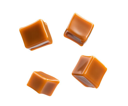 Caramel cubes flying in air isolated on white background. Set of delicious caramel candies floating isolated on white background. caramel cubes. 