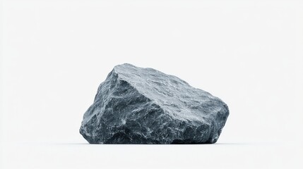 A large, dark gray rock sits on a white background.