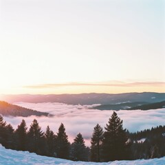 Fototapeta premium Snowy mountain sunrise over the clouds