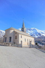 Church of Saint-Laurent in Orcières , France, with Snow-Capped Mountains