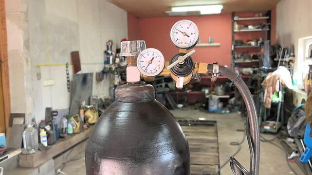 production room. focus on gas cylinder. filled with carbon dioxide. installation of reducer to reduce pressure in cylinder. 4K, UHD, 50p, close-up.