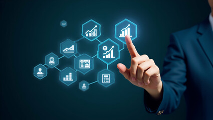 Hand pointing at holographic SME business growth icons with various business related symbols representing growth strategy success of small and medium sized enterprises in empty space concept as Hand p