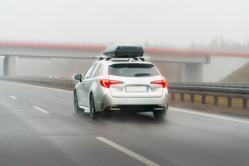 Station wagon moving on scenic countryside road