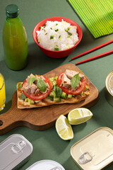 Tuna sandwiches on a table next to lemonade and beer, in a modern interior design