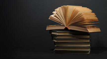 Open book, hardback colorful books on table. Back to school. Copy space for text. Education business concept