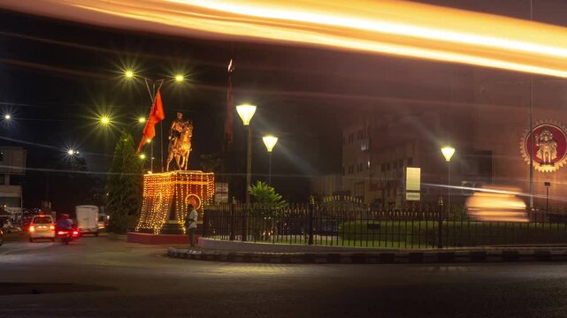4k Hyperapse Timelapse Night footage of Mapusa City in Goa with traffic light trails of vehicles and statue of Shivaji Maharaj