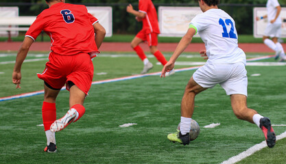 Players Compete in an Energetic Soccer Match on a Vibrant Green Field During a Sunny Afternoon