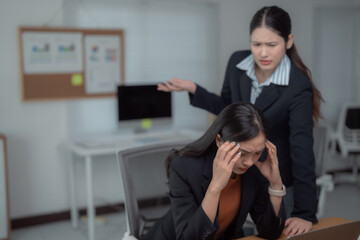 Business woman is having headache and feeling tired from overwork while her manager is arguing and...