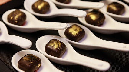 Elegant gourmet chocolate truffles with a touch of edible gold dust,
