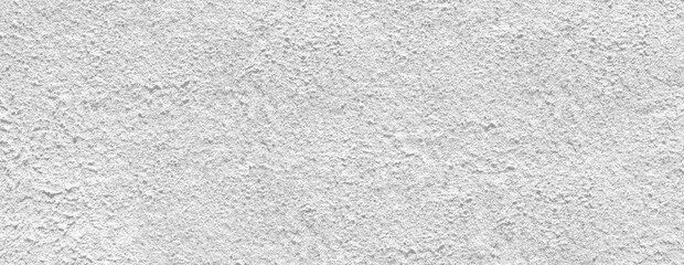 White rough concrete wall texture background providing copy space