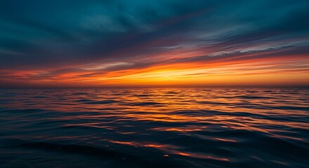 Obraz premium Ocean sunset with golden reflections on water, serene horizon, dramatic sky, peaceful nature scene, evening seascape, calm sea, relaxing beach view, travel inspiration