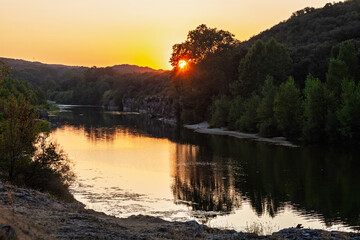 Gorges du Gardon, natural landscape designated UNESCO Biosphere Reserve, and sunset over the canyon carved out by the river Gardon, view near "Pont du Gard", bathed in late afternoon golden light