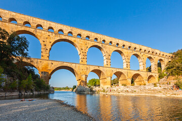 Pont du Gard, ancient Roman aqueduct bridge, Provence late afternoon golden light on arches...