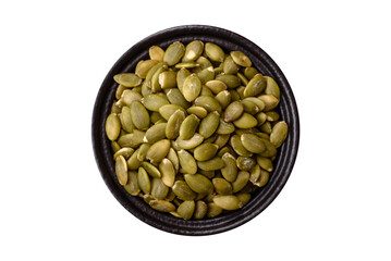 Peeled pumpkin seeds in a bowl, an ingredient for making vegetarian food
