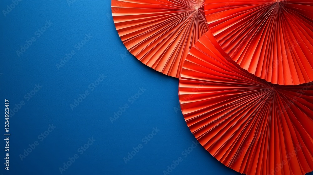Aufkleber top view of three vibrant orange paper fans arranged in a semi-circle pattern against a solid royal 