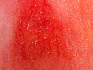 Texture of a red apple as a background macro photo.