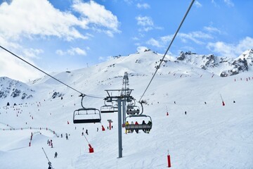 Ski lift  over the slopes of Courchevel ski resort by winter