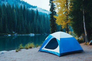 Serene Lakeside Camping - A blue and white tent sits peacefully by a calm lake, surrounded by lush evergreen trees and a mountain backdrop