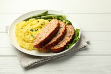 Delicious baked turkey meatloaf with mashed potato served on white wooden table, closeup. Space for text