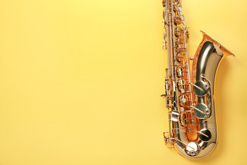 Jazz. One saxophone on yellow background, top view. Space for text