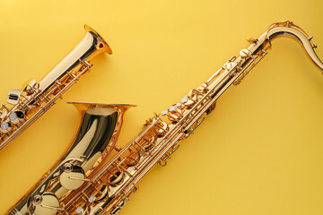 Jazz. Shiny saxophones on yellow background, top view