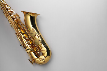 Jazz. One saxophone on light grey background, top view. Space for text