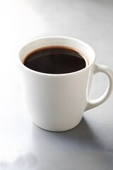 Obraz premium Fresh Brewed Black Coffee in White Mug on Grey Table