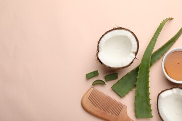 Hair treatment. Fresh coconut, honey, comb and aloe leaves on beige background, flat lay. Space for text