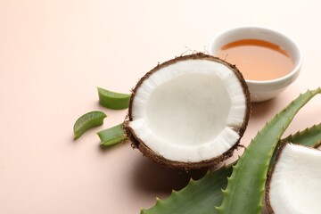 Hair treatment. Fresh coconut, honey and aloe leaves on beige background, closeup. Space for text