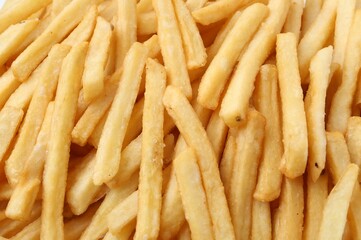 Pile of delicious French fries as background, closeup