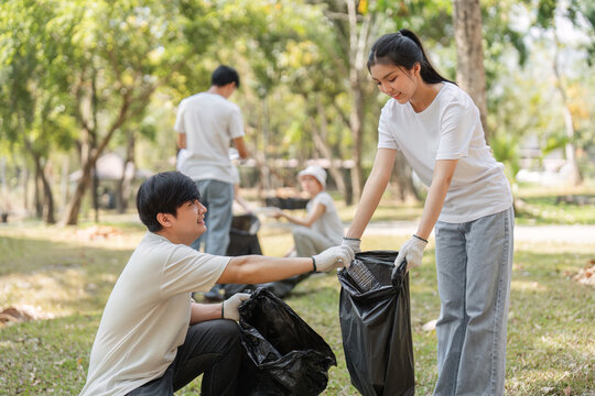 Young volunteers working together to clean up a park, fostering community spirit.