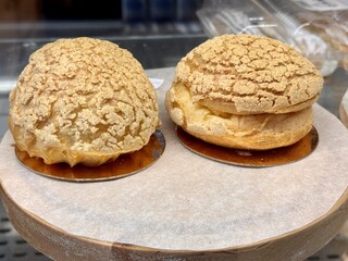 Mouthwatering and Delicious Cream Puffs Beautifully Displayed at the Local Bakery Today