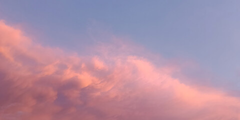 Awesome sunset and soft pink clouds of pastel tones. Dramatic evening light gorgeous photo wallpaper