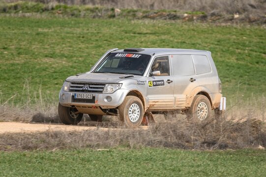 Madrid, Spain; 02-15-2025: Grey Mitsubishi Montero DID powers through an offroad rally stage, kicking up dust as it tackles rugged terrain with precision and endurance