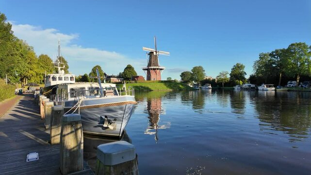 A classic dutch windmill in the city of Dokkum , Friesland, Netherlands