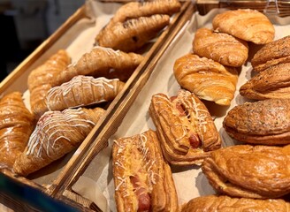 Indulge in the exquisite taste of our Delicious Croissants and Gourmet Pastries, Baked Daily. A tempting selection of freshly baked golden croissants and pastries, perfect for any bakery display