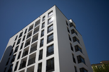 A Modern Apartment Building Standing Tall Against The Clear Blue Sky Displaying Architectural Beauty