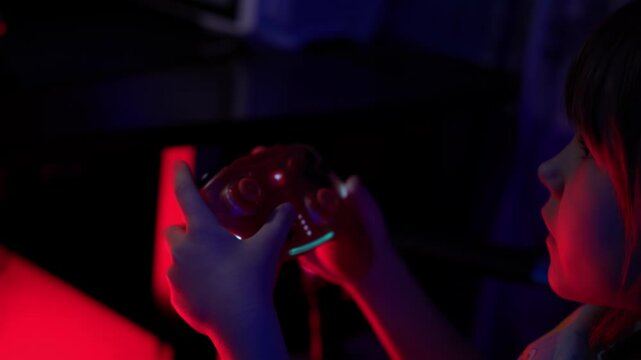 A preschool-age girl plays games using a joystick