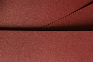Fototapeta premium Burgundy paper background with a smooth texture and a metallic, glossy finish. Rich, warm tones create an elegant, luxurious design, perfect for premium stationery and sophisticated, modern artistic.