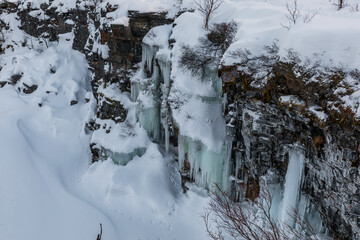 Mountain river canyon covered with snow. Beautiful sunset.Abisko National Park, Lapland, Sweden.