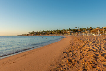 Summer background with tropical beach during sunset. Holiday vacation and travel concept.