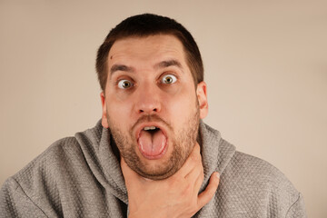 The discomfort on his face shows the urgency of the moment, as he struggles with breathing or a...