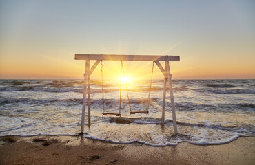 Waves Crashing Around Beach Swing at Sunrise