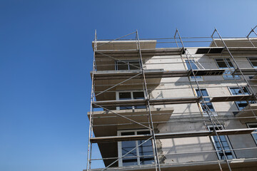 A Modern Building Under Construction features Scaffolding and is progressing rapidly