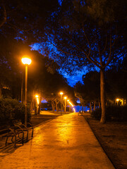 Evening stroll along a beautifully lit pathway in Barcelona, Spain