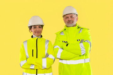 Professionals in safety gear stand confidently against vibrant yellow background showcasing their commitment to workplace safety and teamwork