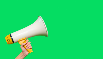 Hand holding a megaphone against a bright green background, perfect for announcing events or gatherings