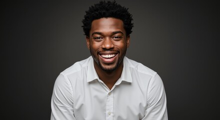Fototapeta premium Cheerful African American man with beaming smile in a white shirt on gray background. Headshot portrait for business, advertising, marketing. Professional corporate headshot.