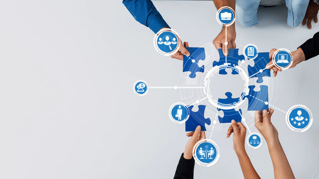 Hands engaged in collaborative puzzle assembly represent teamwork and innovation. A visual metaphor for problem-solving and strategic connections in a modern workspace. Amity